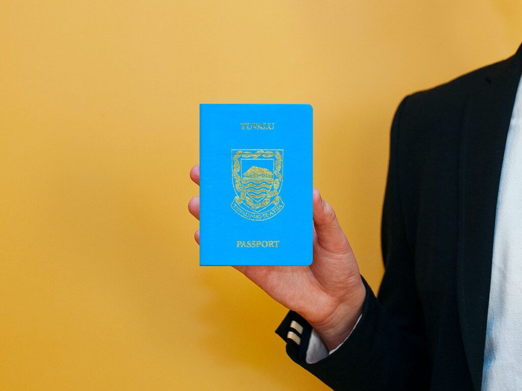 Person holding Tuvalu passport
