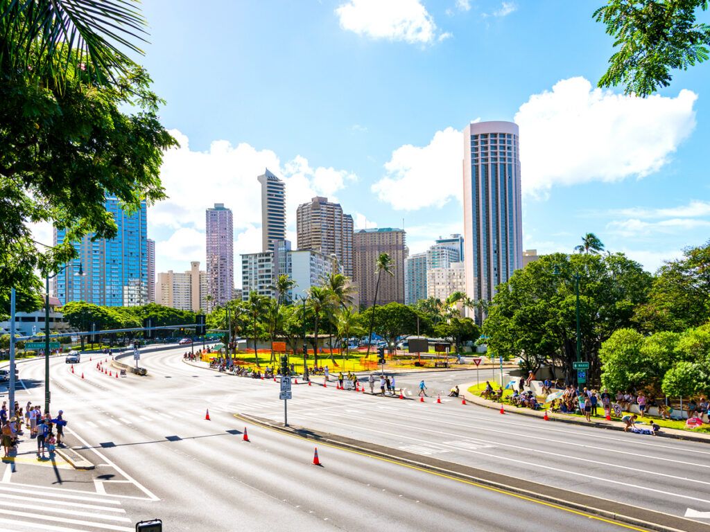 Empty street beside Honolulu skyscrapers