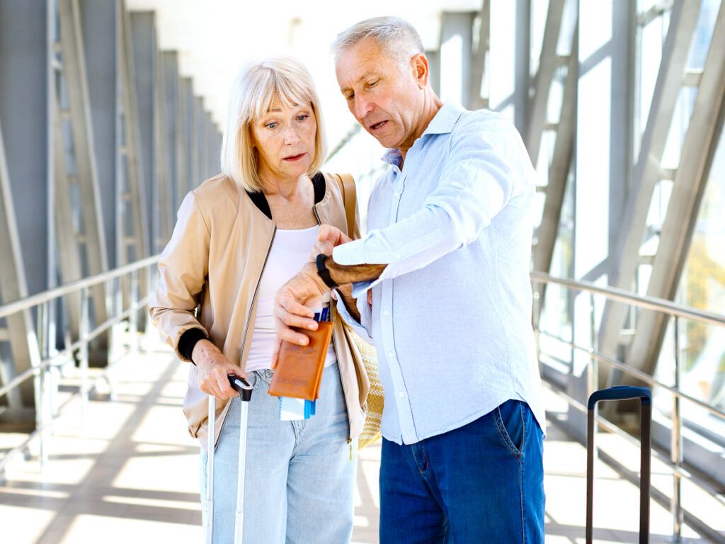 Couple in airport looking at the time