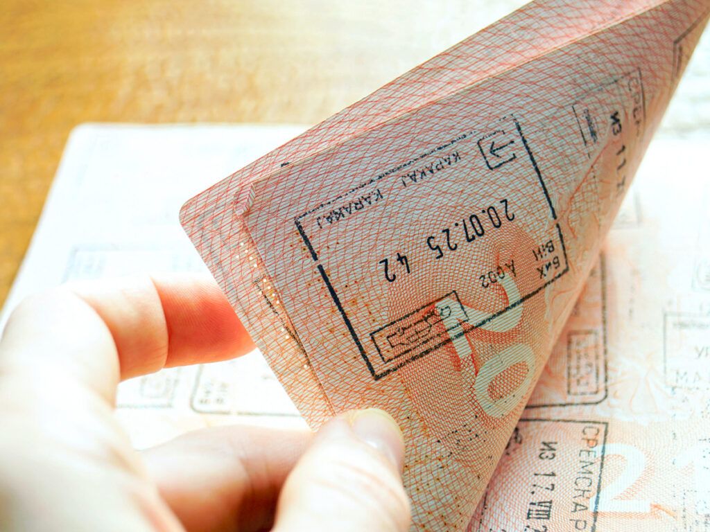 Person flipping through pages of passport book