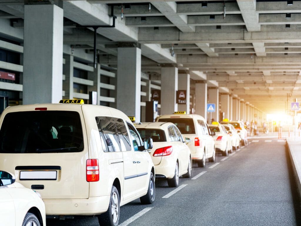 Line of taxis outside airport terminal