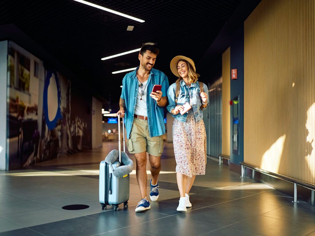 Couple walking through airport terminal