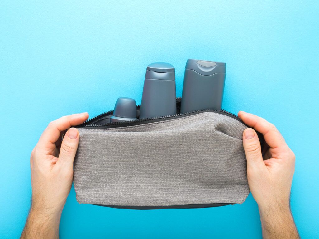 Person holding toiletry bag