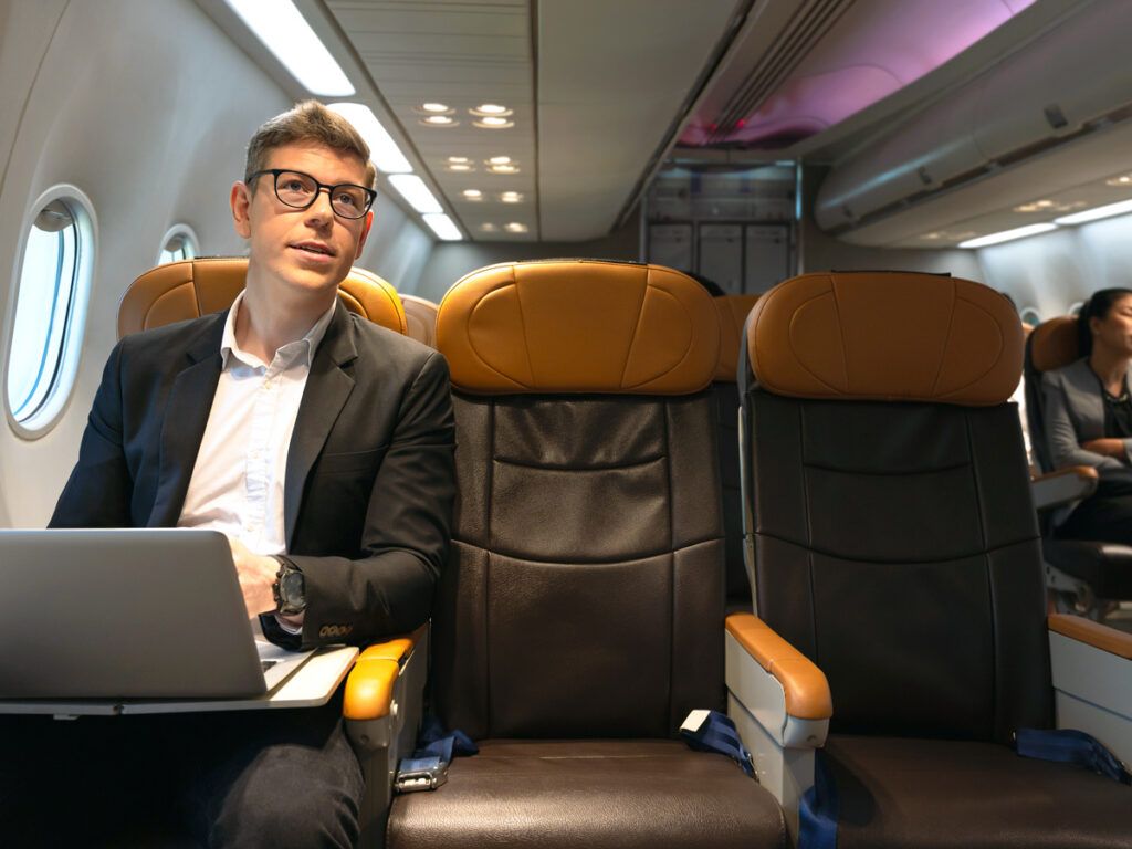 Passenger in window seat with two empty seats next to him