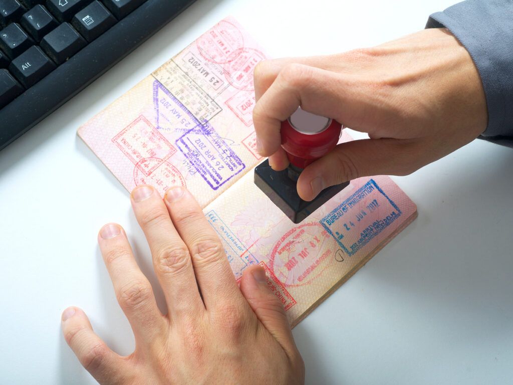 Immigration officer stamping passport