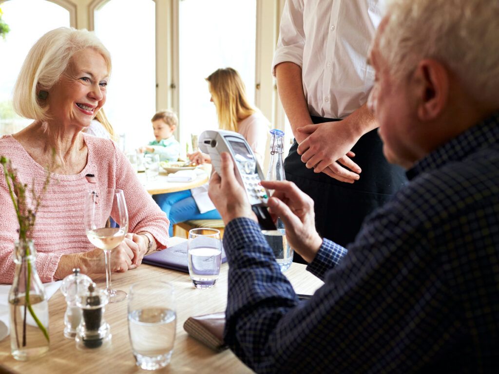 Diner paying bill on credit card terminal