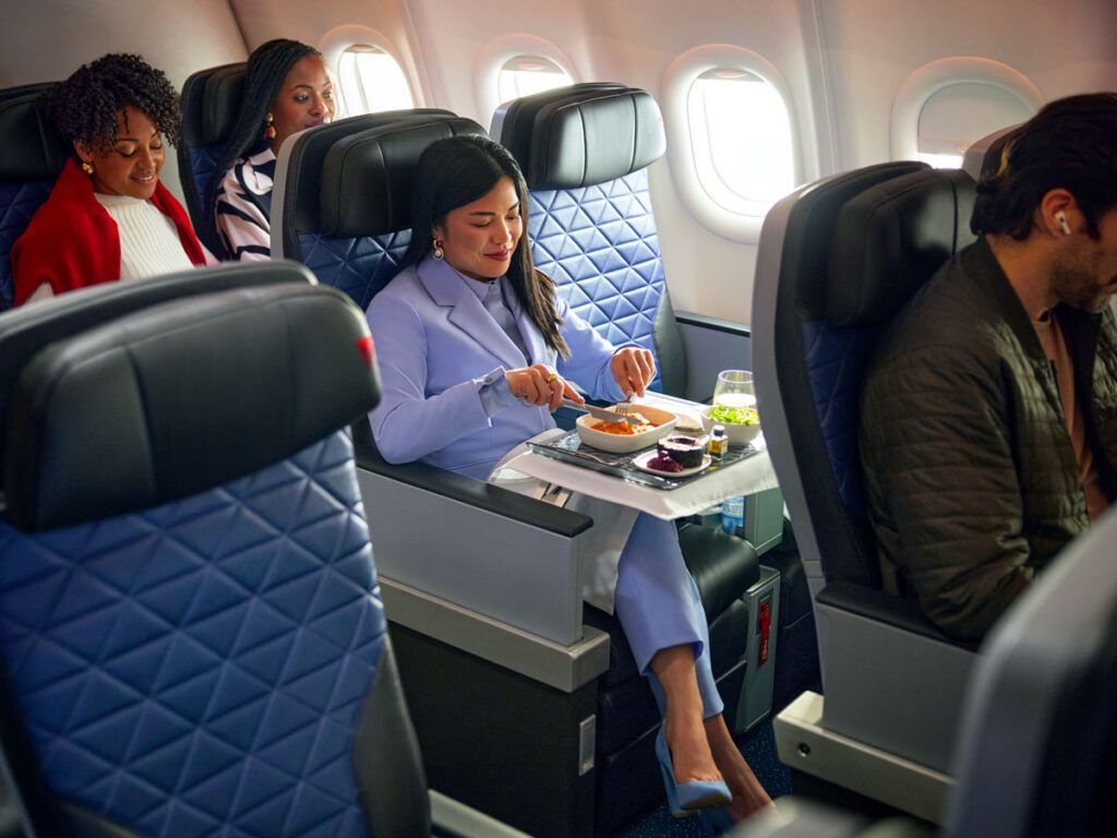 Passenger dining in Delta's Premium Select cabin