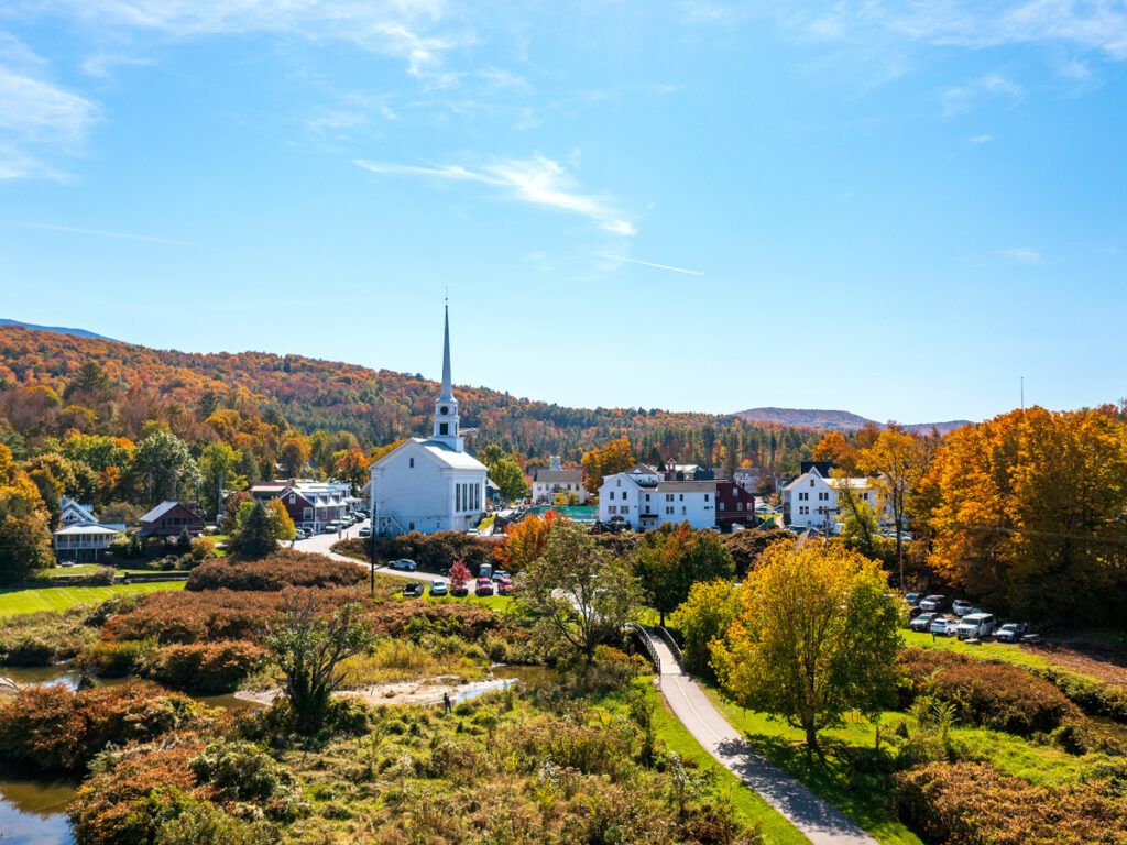 White church surrounded by rolling hills in Vermont
