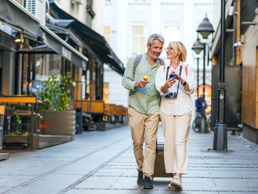Couple walking on street eating ice cream cones
