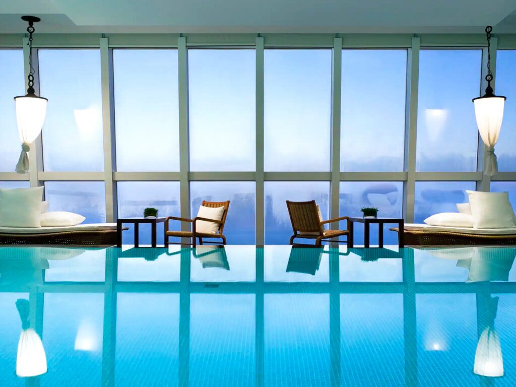 Pool and lounge chairs overlooking Hong Kong skyline
