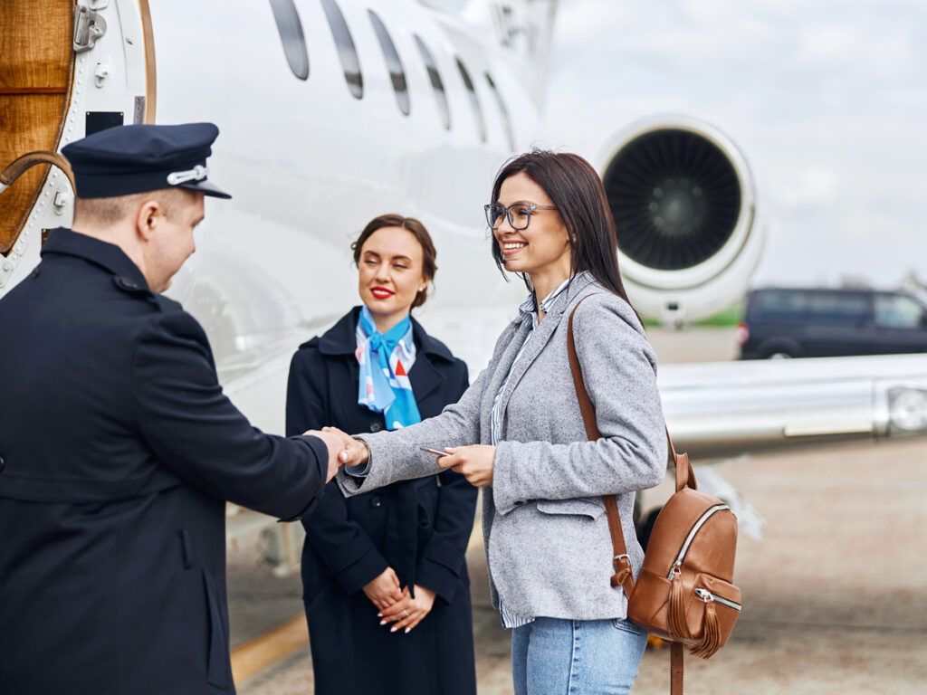 Traveler shaking pilot's hand as they board aircraft