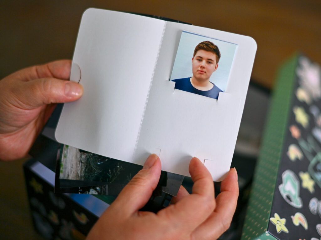 Person holding a passport photo