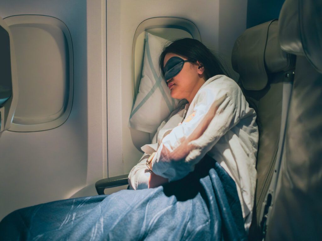 Woman sleeping in airplane seat