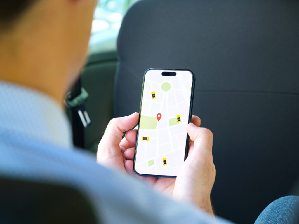 Person using taxi app on phone
