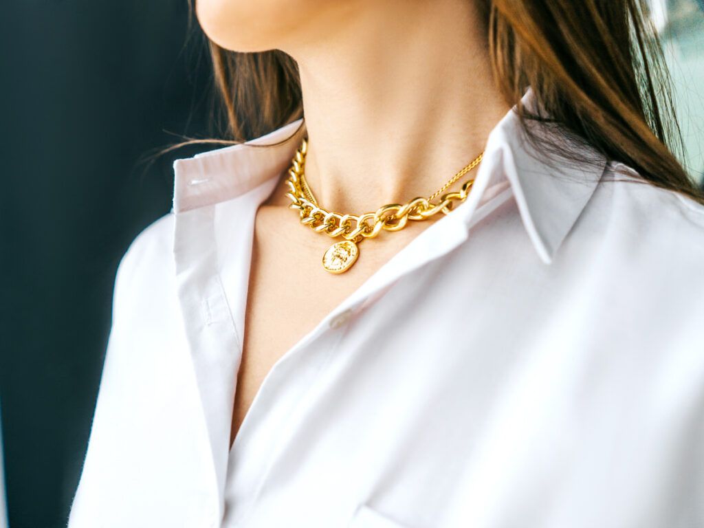 Woman wearing gold necklace