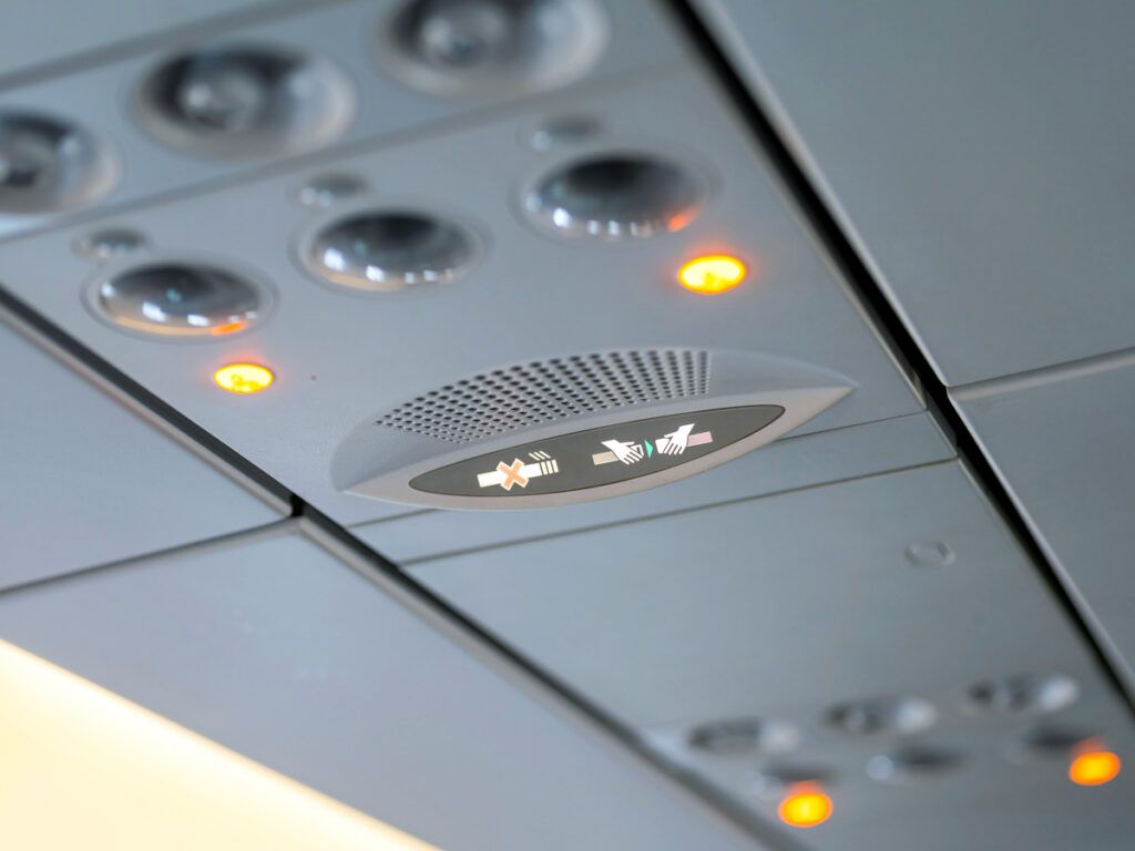 Fasten seatbelt and no-smoking signs on airplane panel