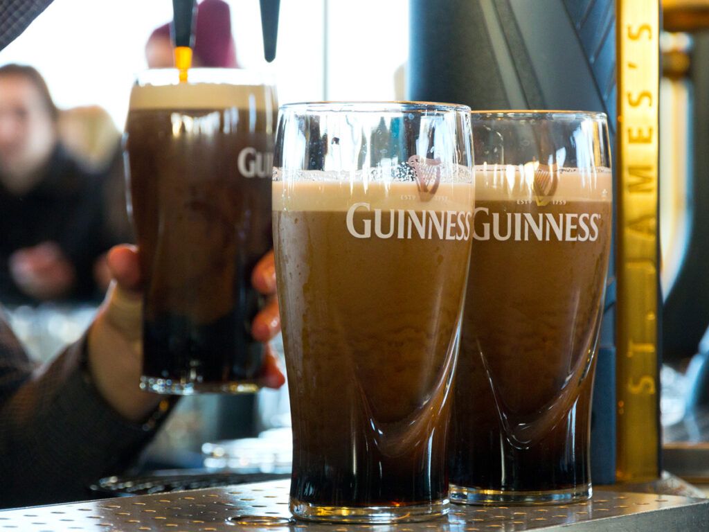 Bartender pouring pints of Guinness