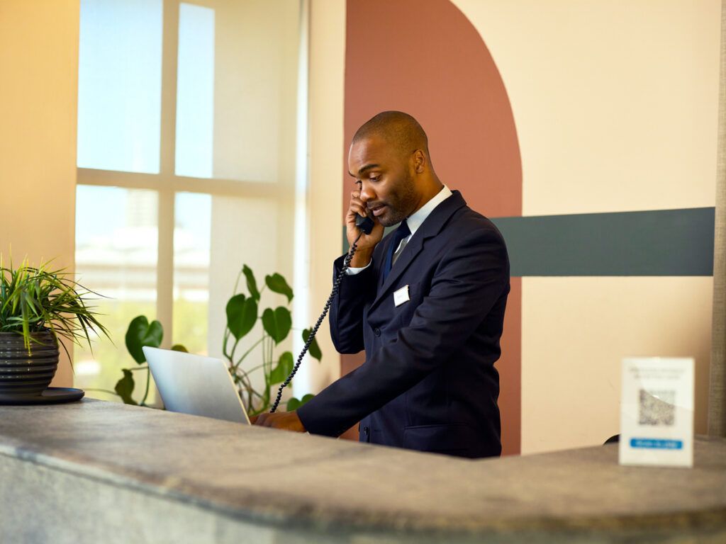 Hotel receptionist speaking on phone