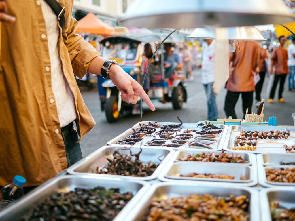 Tourist buying food at outdoor stall