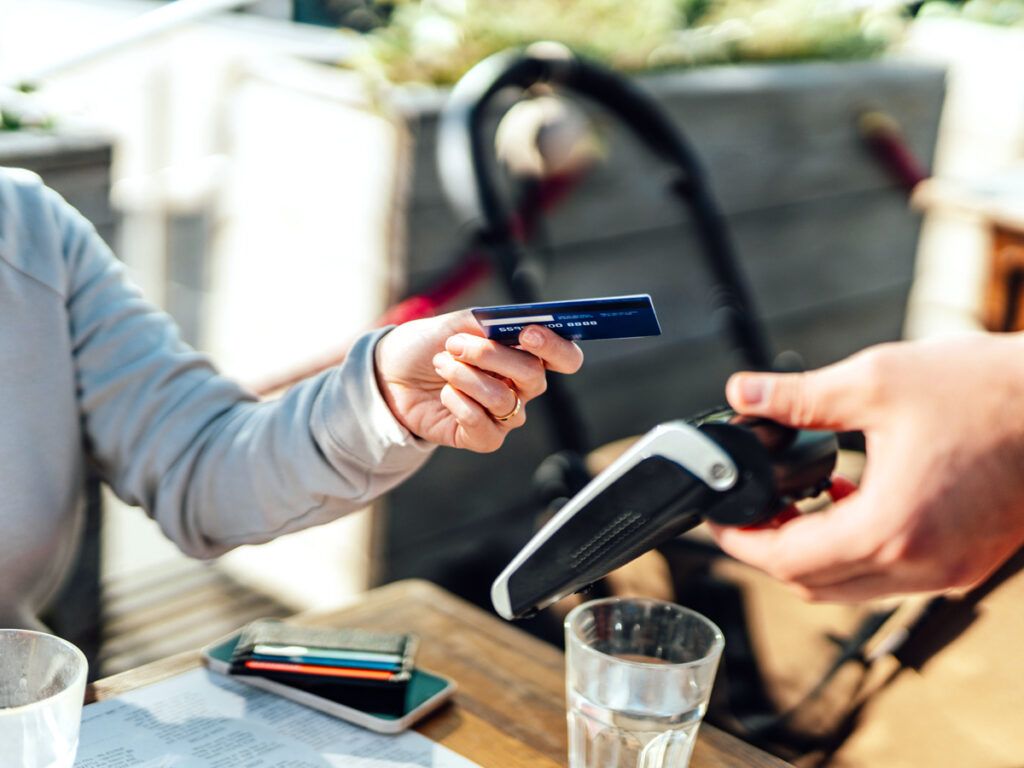 Customer handing over credit card to pay