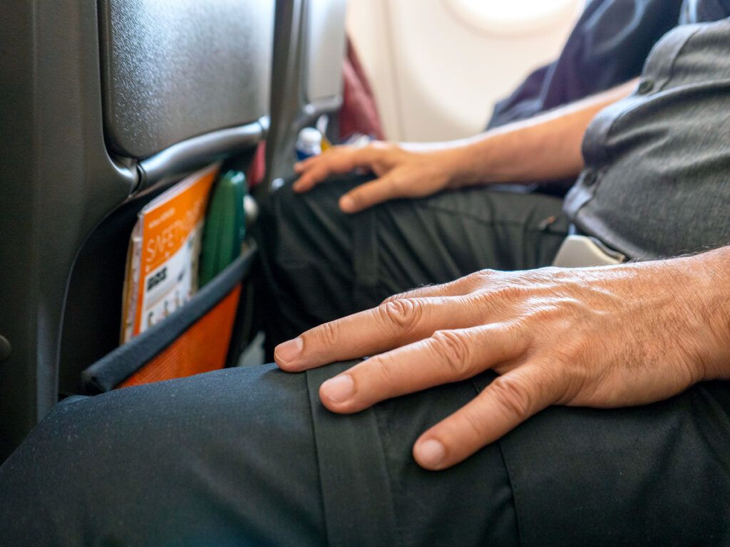 Passenger in tight economy-class seat