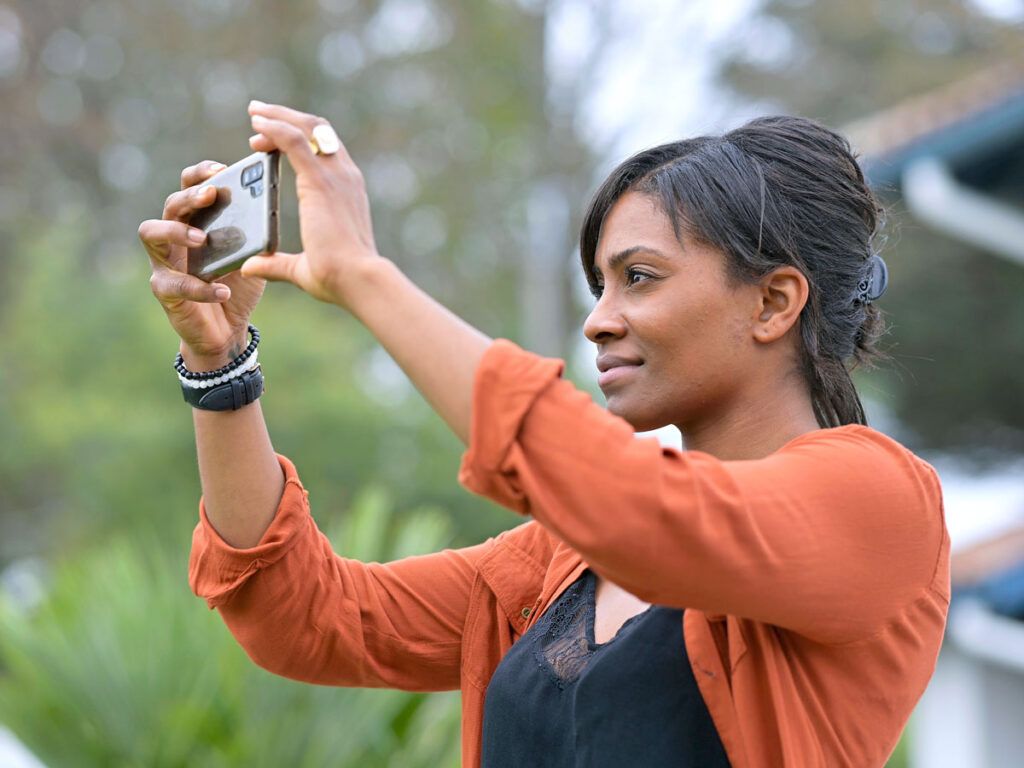 Woman taking photo with phone