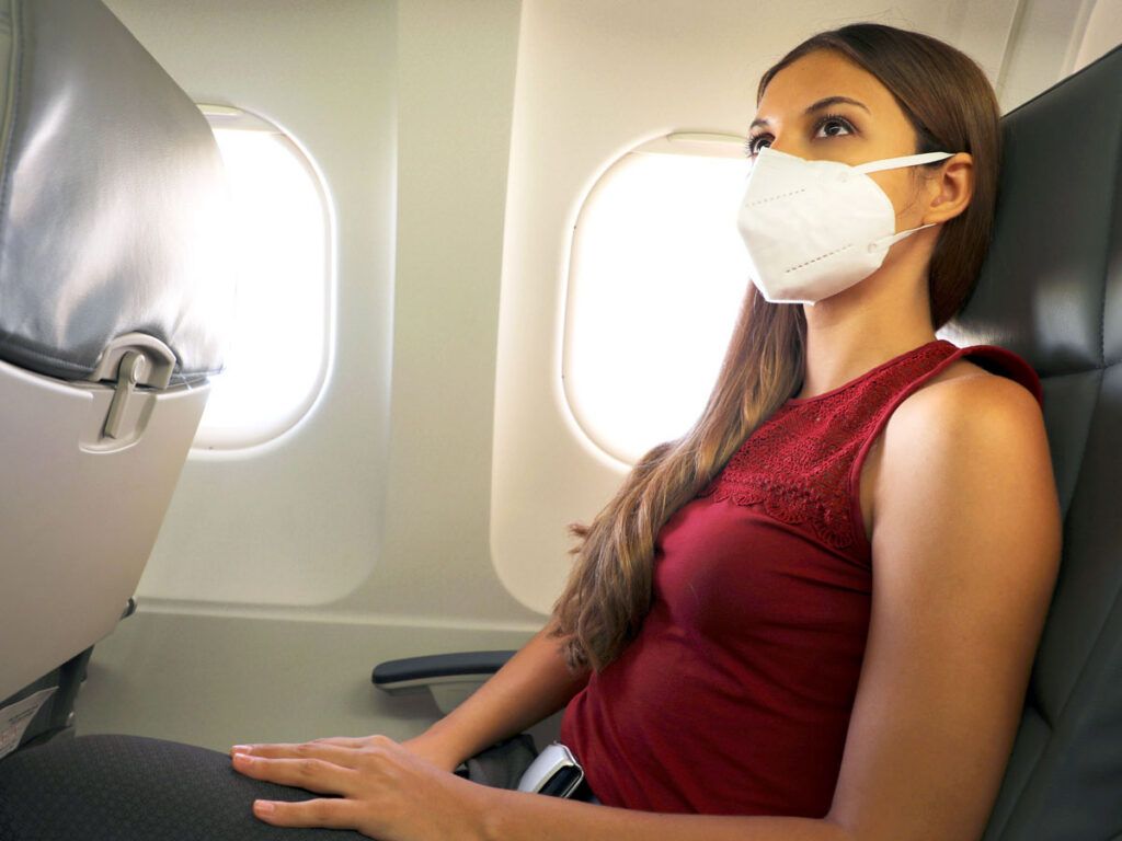 Passenger wearing mask on airplane