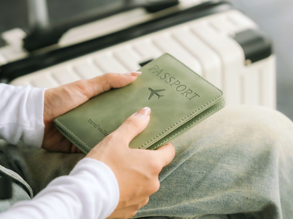 Person holding passport on lap