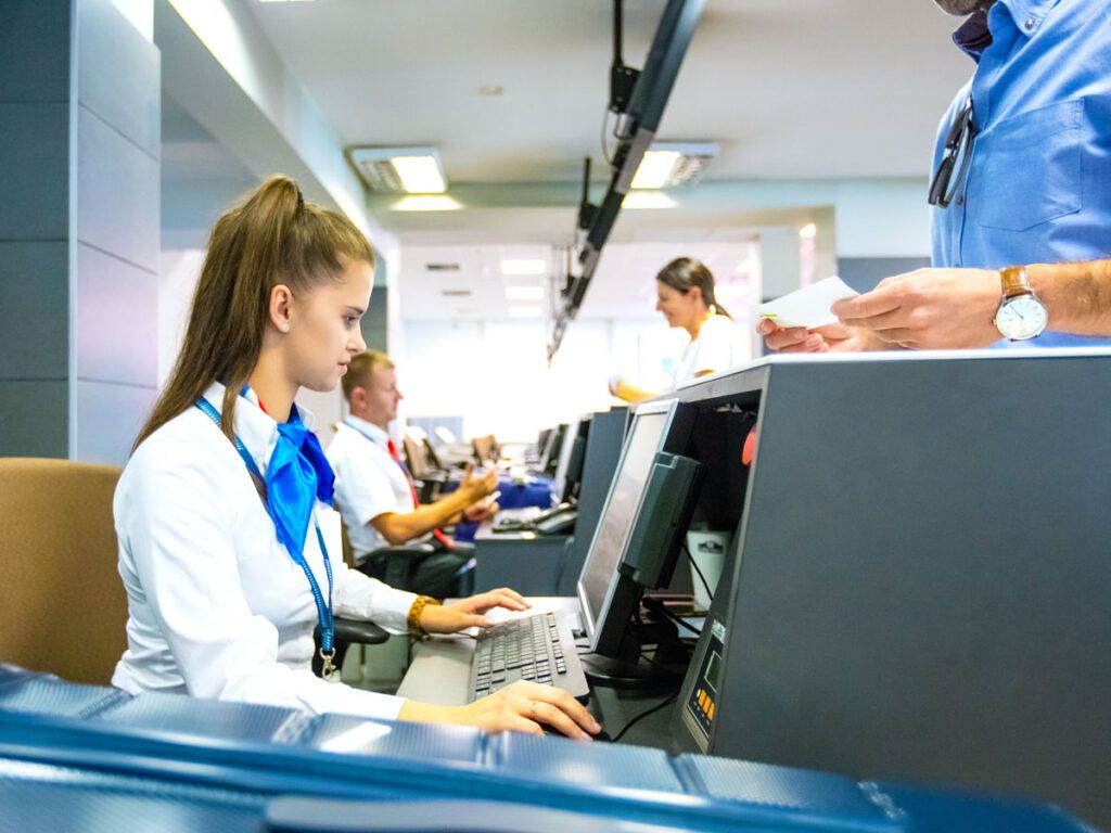 Airline check-in agent typing on computer