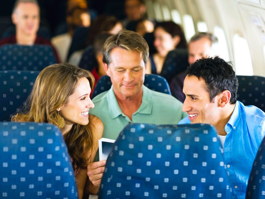 People conversing on airplane