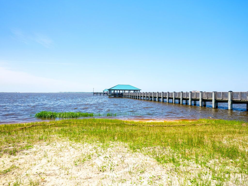 Pier extending from beach in Ocean Springs, Mississippi