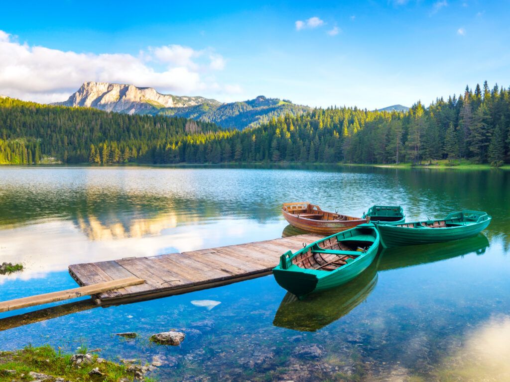 Rowboats docked in mountain lake in Montenegro