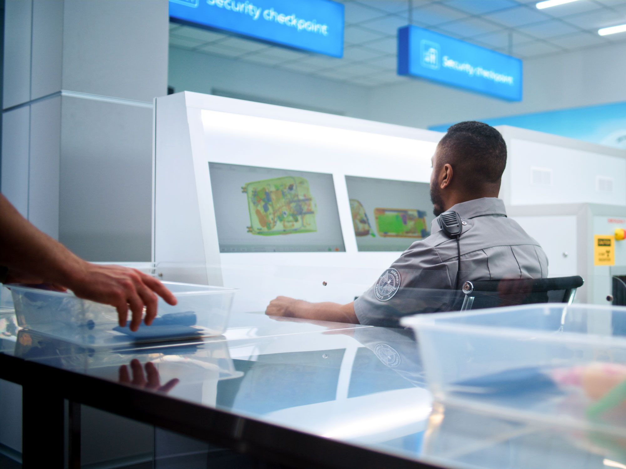 Security officer viewing bag contents on screen