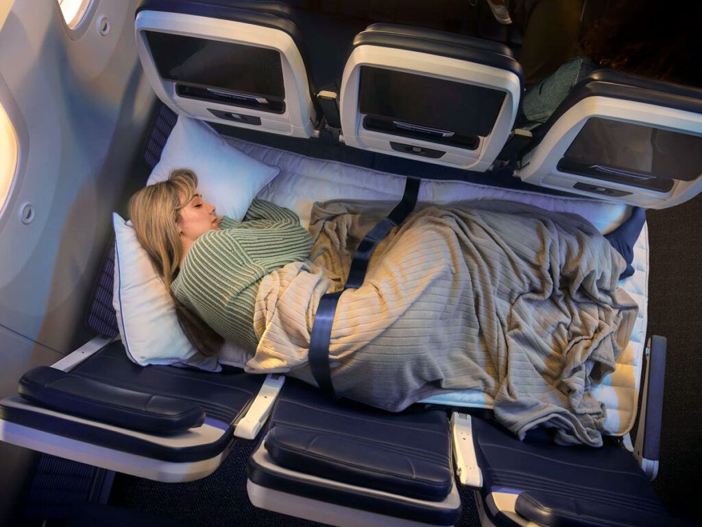 Passenger sleeping in United's Relax Row, seen from above