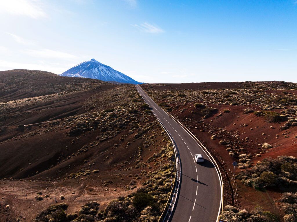 Car drives across the volcanic landscape in Spain