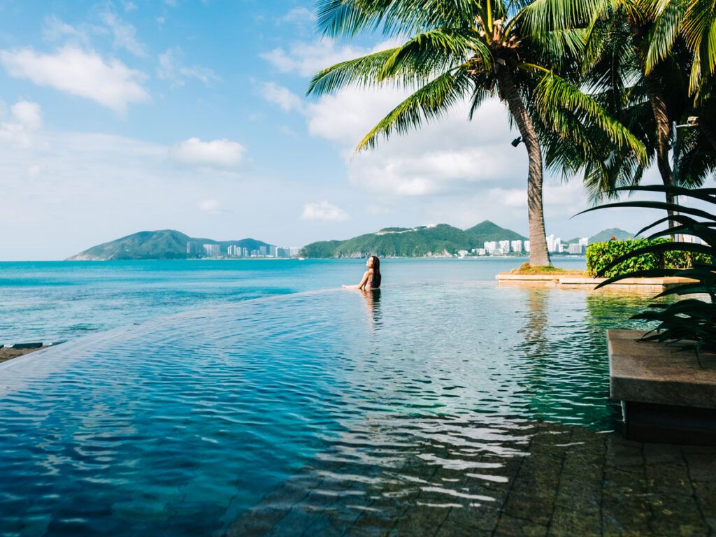 Woman relaxes in a pool by the coast
