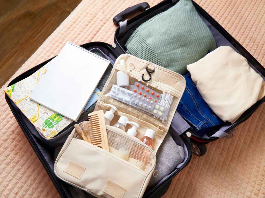 Open suitcase with toiletries