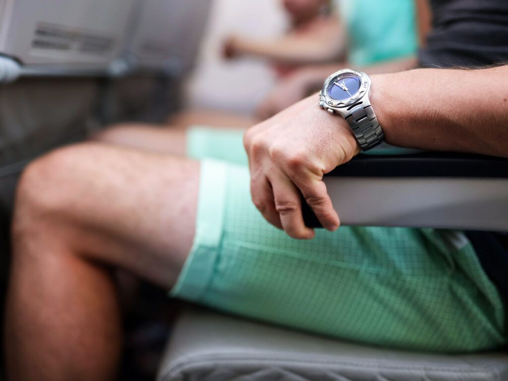 Man using an armrest on a plane