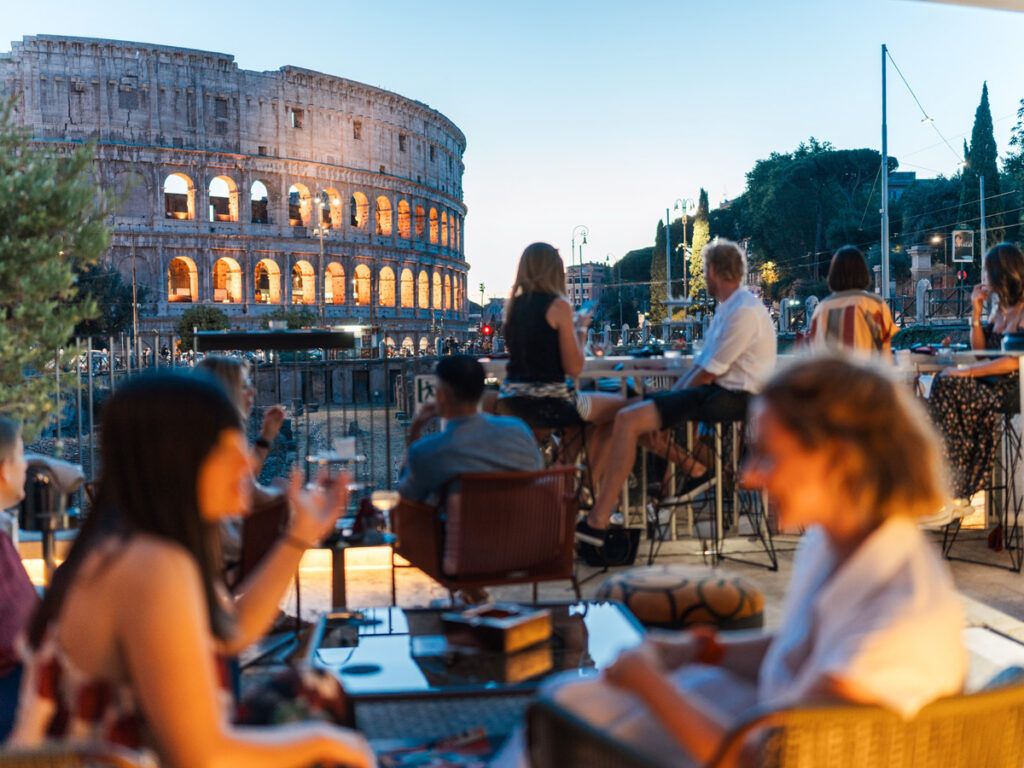 Tourists enjoy dining near the Colosseum in Rome