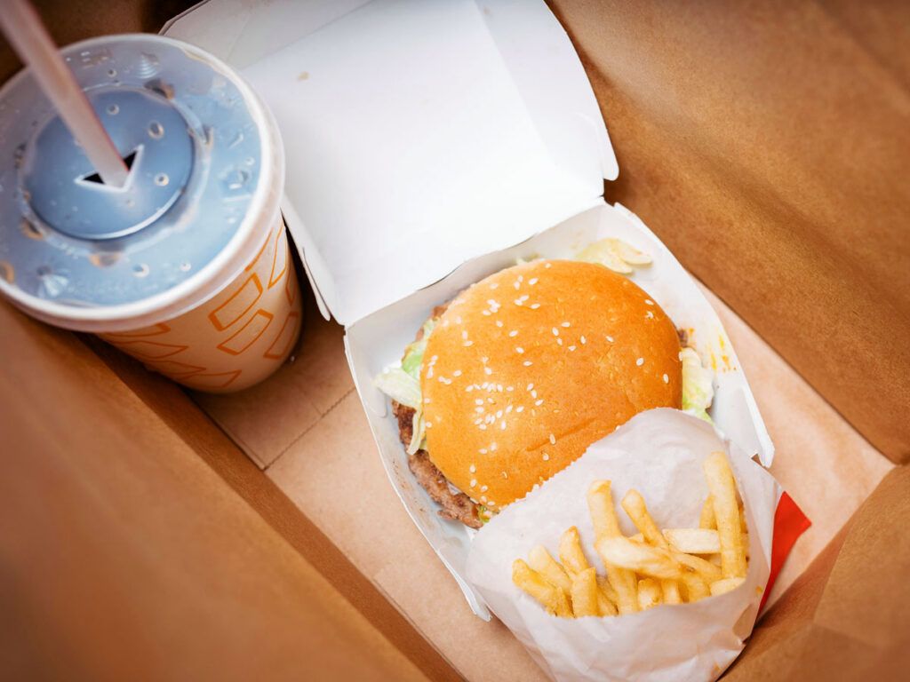 A burger, French fries, and a fountain drink