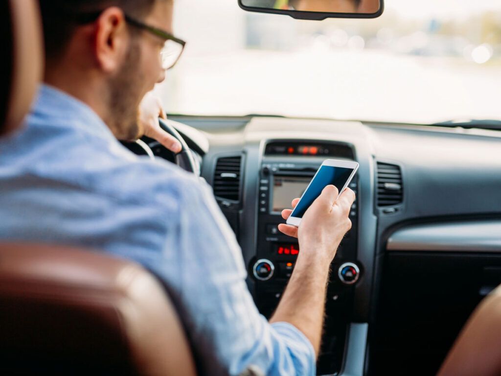 Man driving and texting