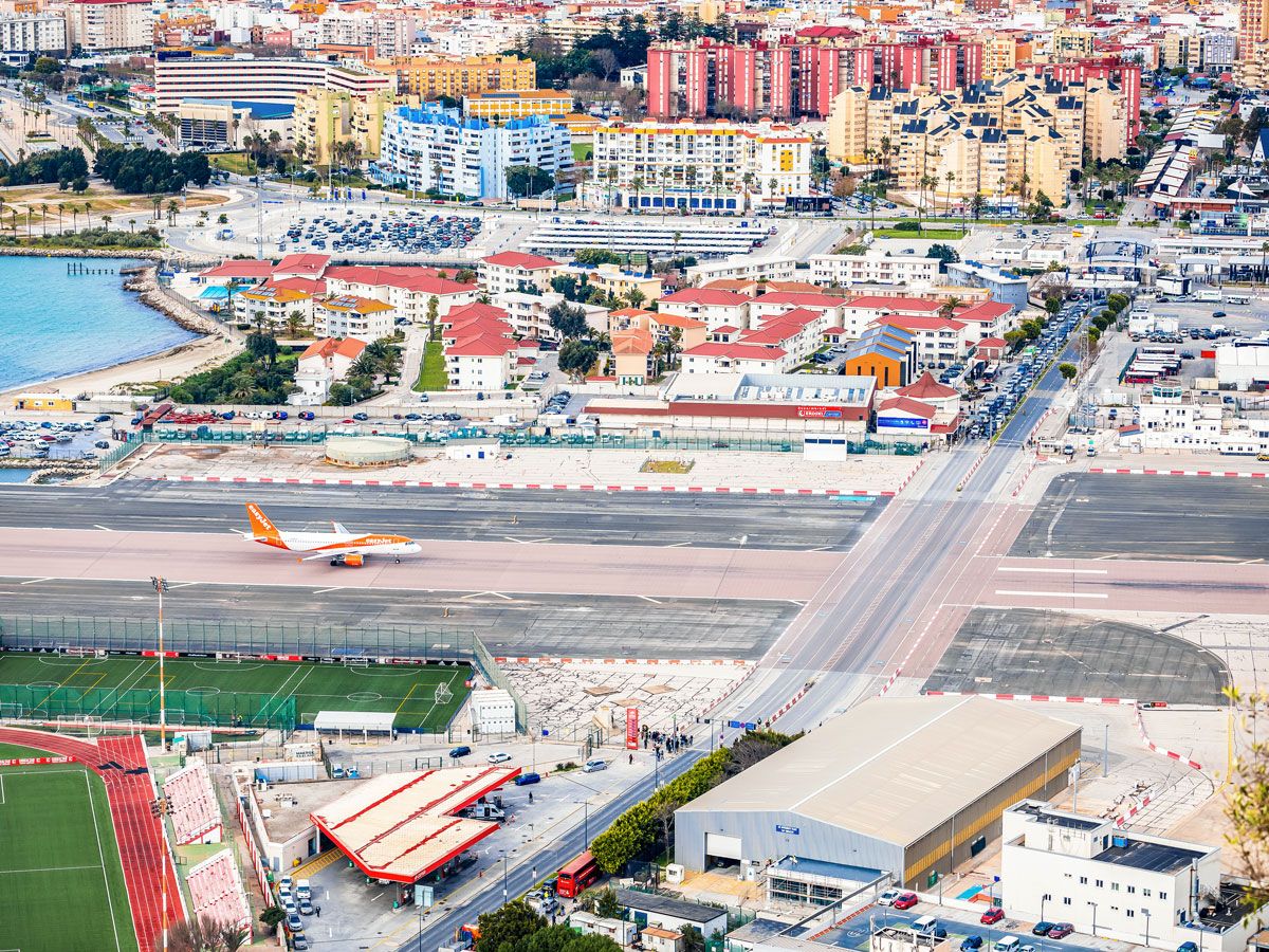 Aerial view of runway at Gibraltar International Airport with Winston Churchill Avenue intersecting
