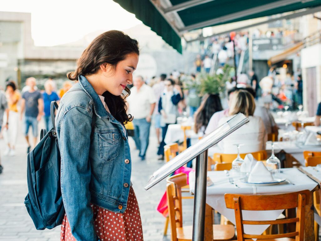 Woman reads a menu for a restaurant