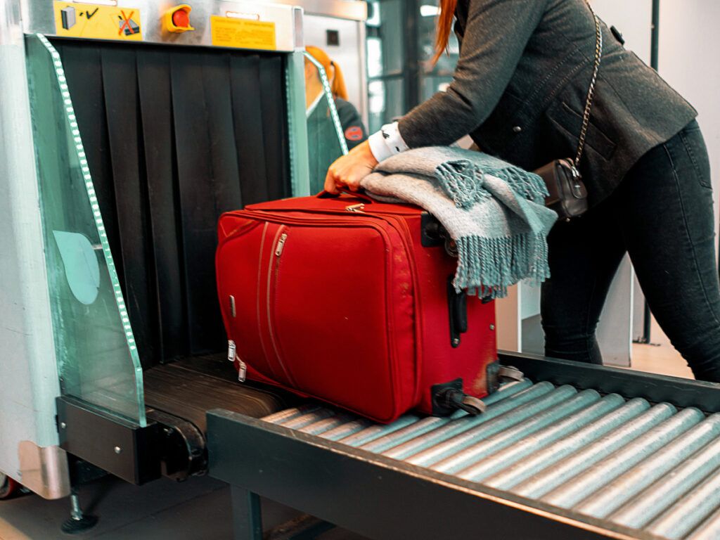 Suitcase going through a security checkpoint at the airport