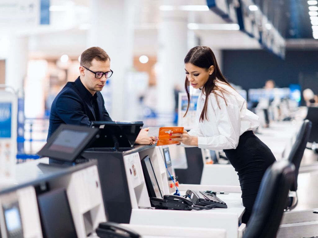 Airline front desk agent assists a passenger