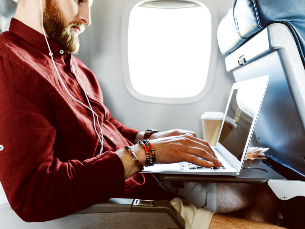 Man on a laptop aboard a flight