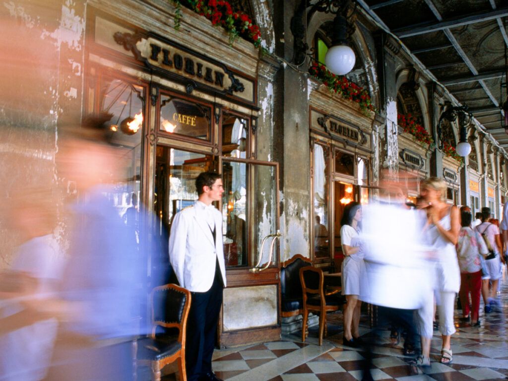 People walking in front of Caffè Florian in St. Mark's Square in Venice, Italy