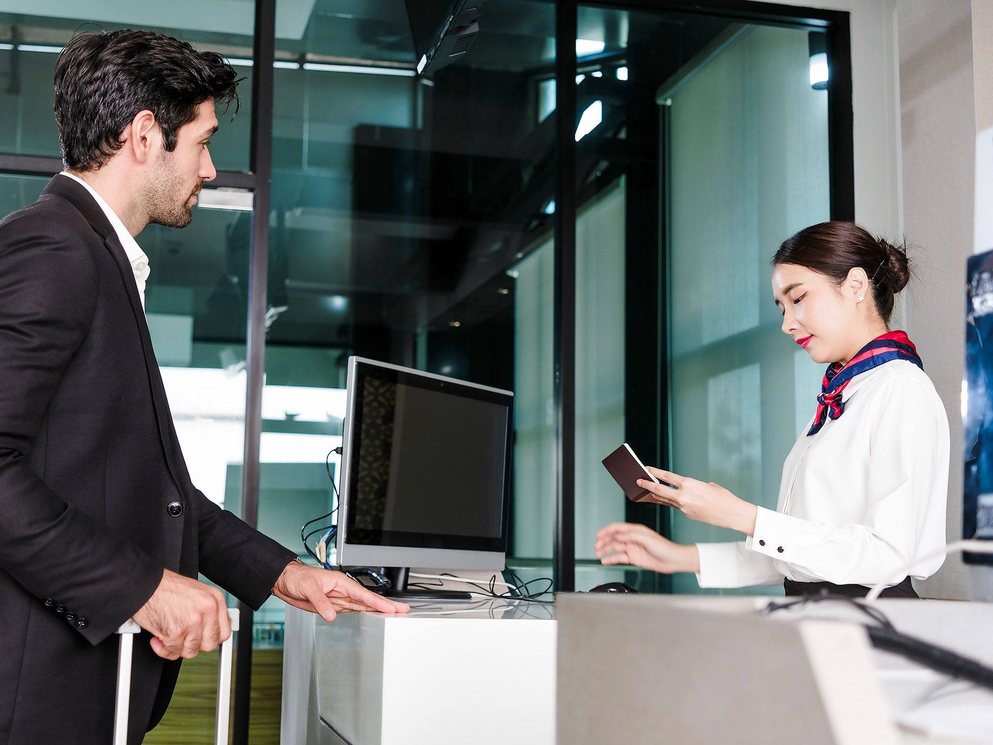Gate agent checking a traveler's passport