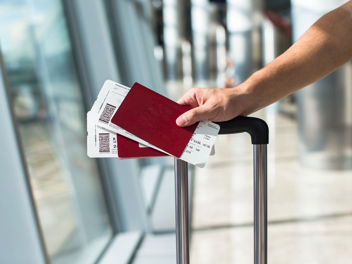 Passenger holding passports and boarding passes