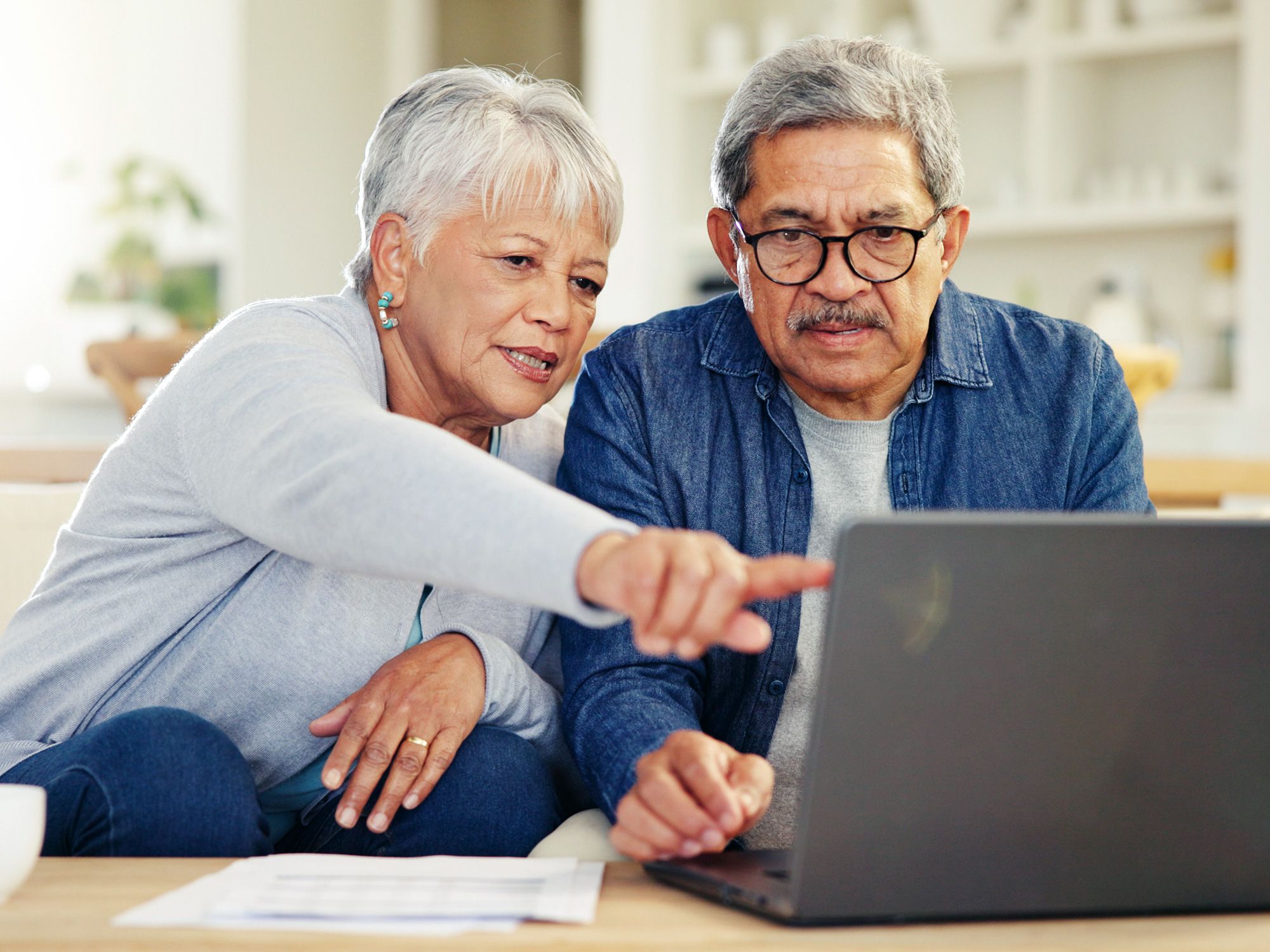 Senior couple working on laptop computer